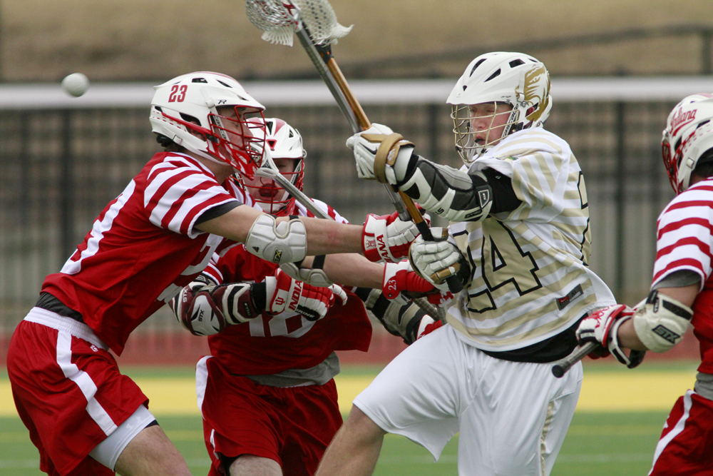 Attackman John Gilmore (24) gets hit from all sides Saturday against Indiana. Gilmore scored on of Missouri's five goals.